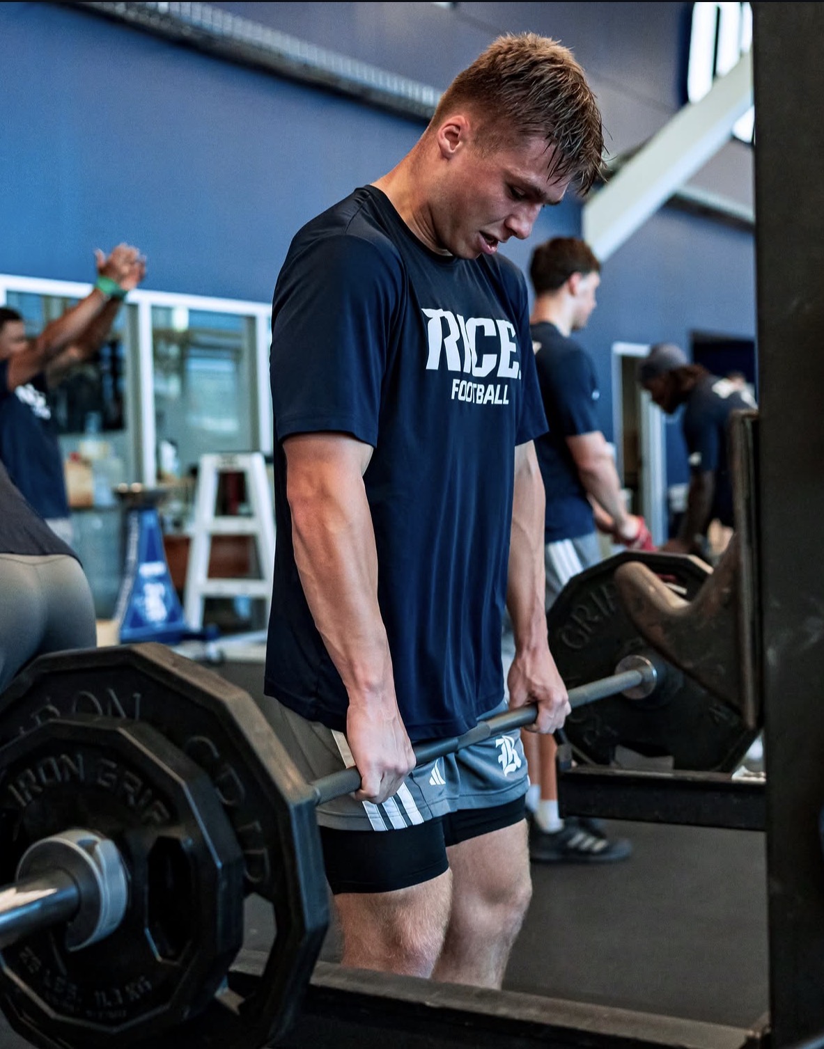 Caden VerMaas performing a heavy barbell row at Rice Football